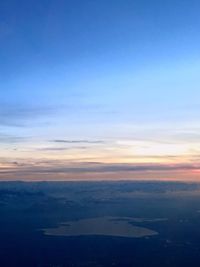 Scenic view of landscape against sky at sunset