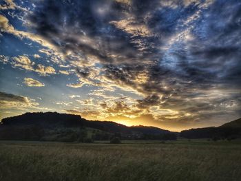 Scenic view of field against sky during sunset
