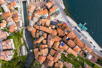 High angle view of townscape by river in city