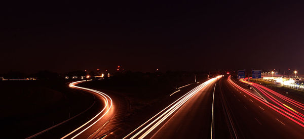 High angle view of light trails on highway at night