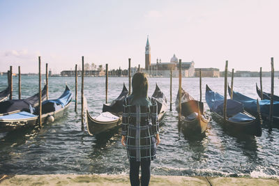 Rear view of boats in canal