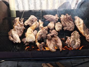 High angle view of meat on barbecue grill