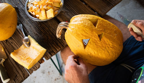 Cropped hand of person holding food on table