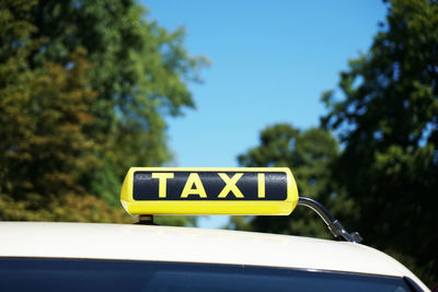 Information sign on taxi against sky