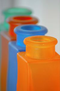 Close-up of multi colored bottles on table