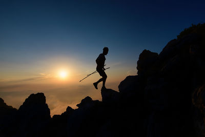Low angle view of man walking on mountain