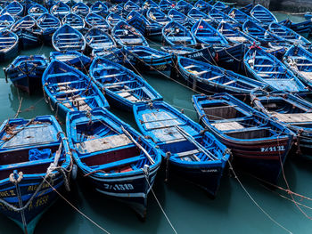 Blue boats moored at harbor