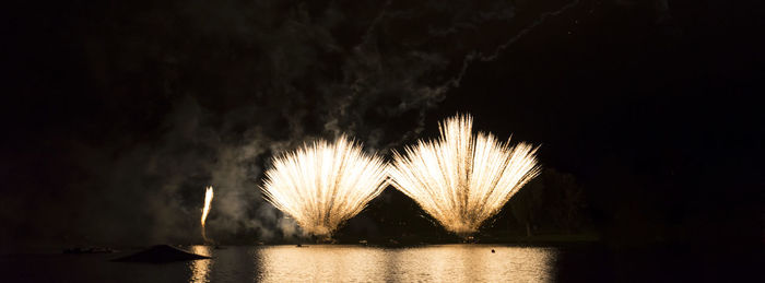 Firework display over lake at olympiapark during night