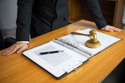 High angle view of man using smart phone on table