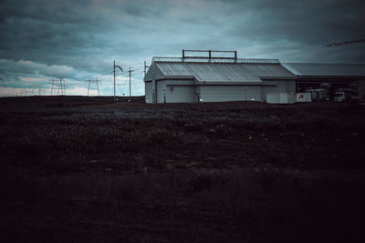 Built structure on field against sky