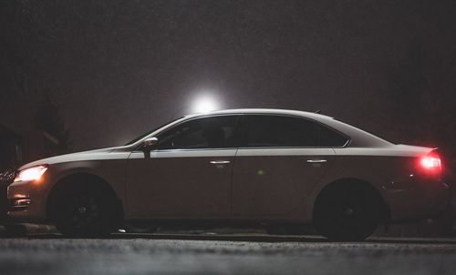 Illuminated street light on road at night