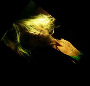 Woman lying down over black background