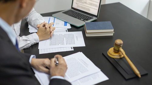 Midsection of business colleagues working on table