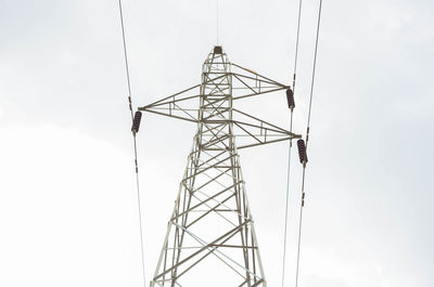 Low angle view of electricity pylon against sky