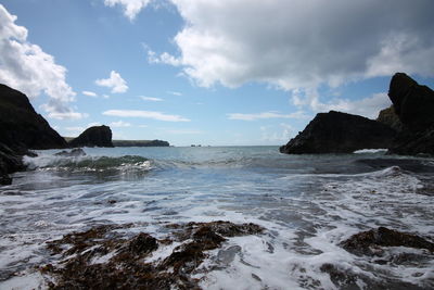 Scenic view of sea against cloudy sky