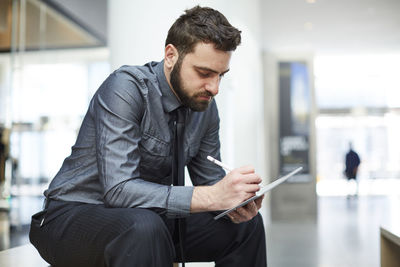 Mid adult man using mobile phone