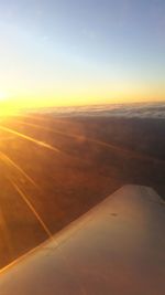 Cropped image of airplane flying over landscape