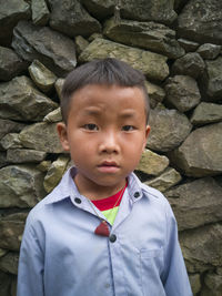 Portrait of cute boy standing outdoors