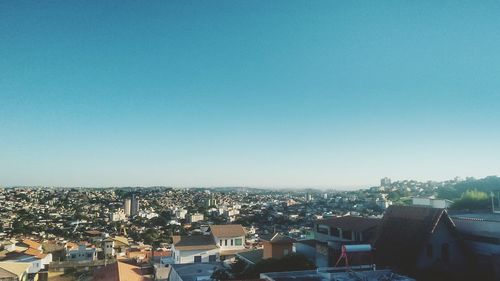 Scenic view of residential district against clear blue sky