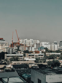 Buildings in city against clear sky