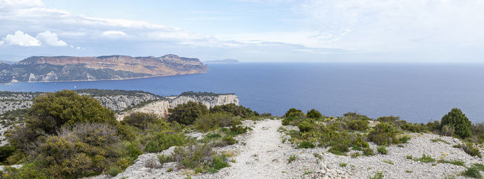 Scenic view of sea and mountains against sky