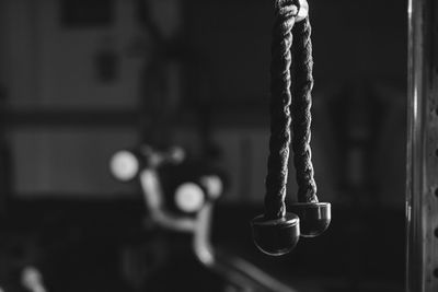 Close-up of metal hanging on rope