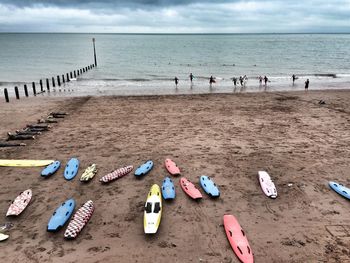 Garbage on beach by sea against sky
