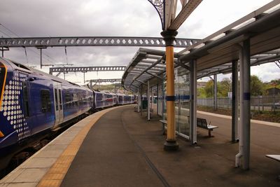 Train at railroad station against sky