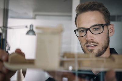 Architect looking at architectural model