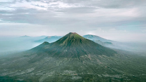 Scenic view of mountain against cloudy sky