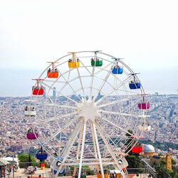 Ferris wheel in amusement park against sky