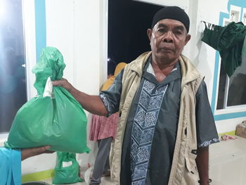 Portrait of mid adult man standing at store