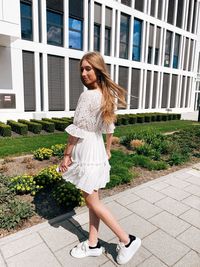 Full length of woman standing against plants