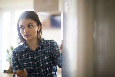 Young woman standing in the kitchen