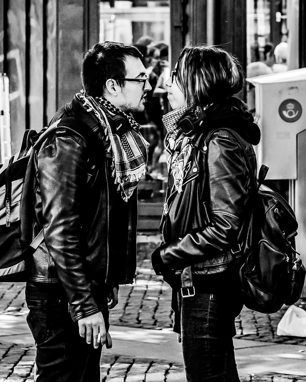 real people, two people, city, architecture, three quarter length, building exterior, street, lifestyles, adult, women, day, casual clothing, built structure, togetherness, walking, people, leisure activity, men, jacket, focus on foreground, outdoors, leather, leather jacket, positive emotion, couple - relationship, warm clothing, hairstyle