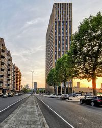 View of city street and buildings against sky