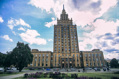 Buildings in city against cloudy sky