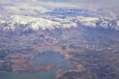 Wasatch front rocky mountain range aerial snow capped peaks winter urban salt lake city utah usa