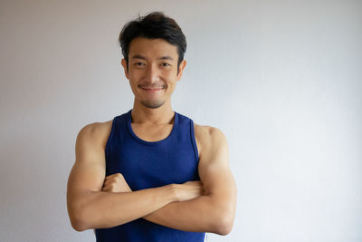 Portrait of smiling young man against white background