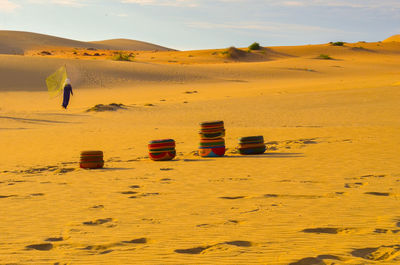 Scenic view of sand dunes in desert against sky