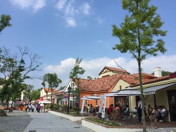 Group of people in building against sky