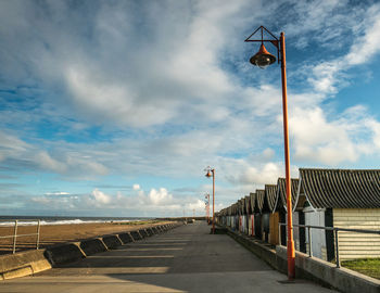 Street light by road against sky