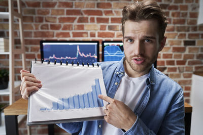 Portrait of young man working at office