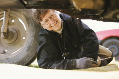 Woman repairing tractor