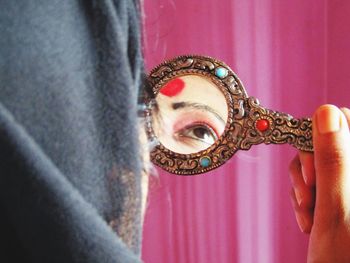 Close-up portrait of woman holding mask