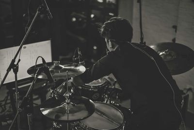 Man playing drum n darkroom