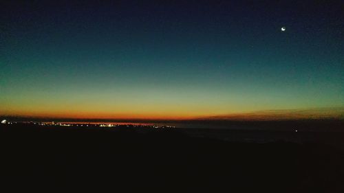 Scenic view of silhouette landscape against sky at night