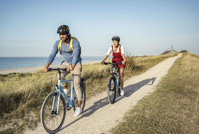 People riding bicycle on road