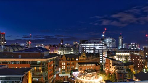 High angle view of city lit up at night