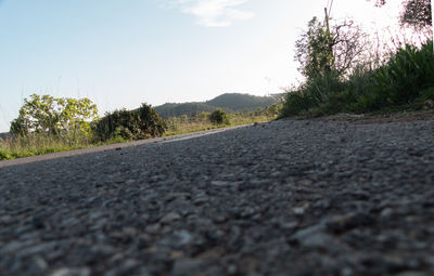 Surface level of road against clear sky